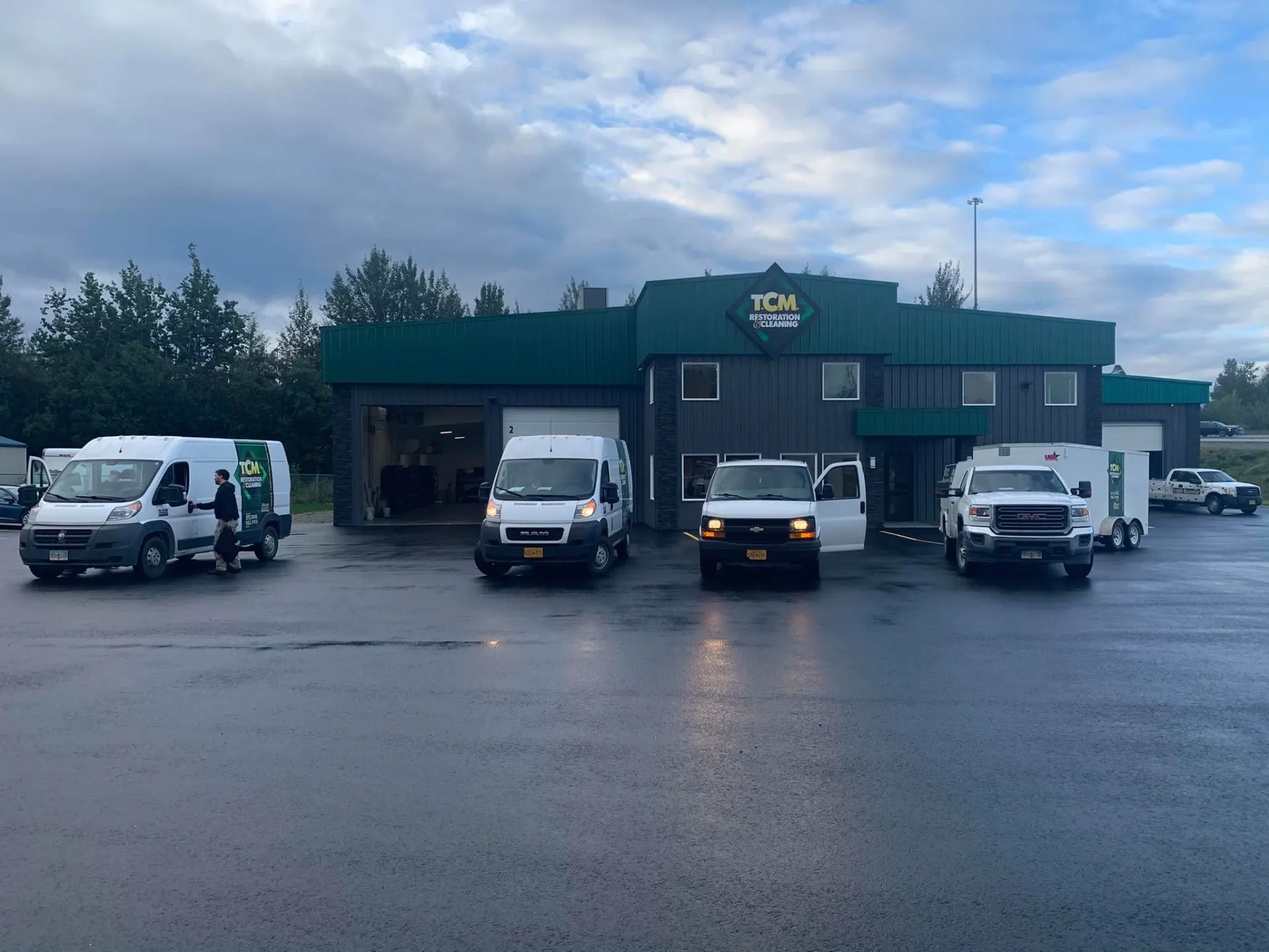 TCM Restoration response vans and box trucks staged outside the TCM facility